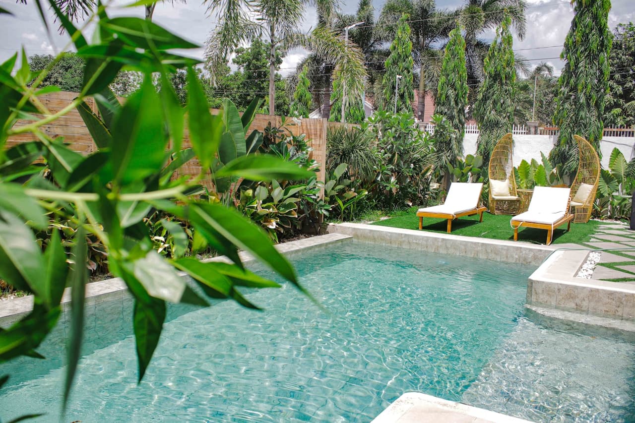 IL Bayou swimming pools with sun loungers and palm trees