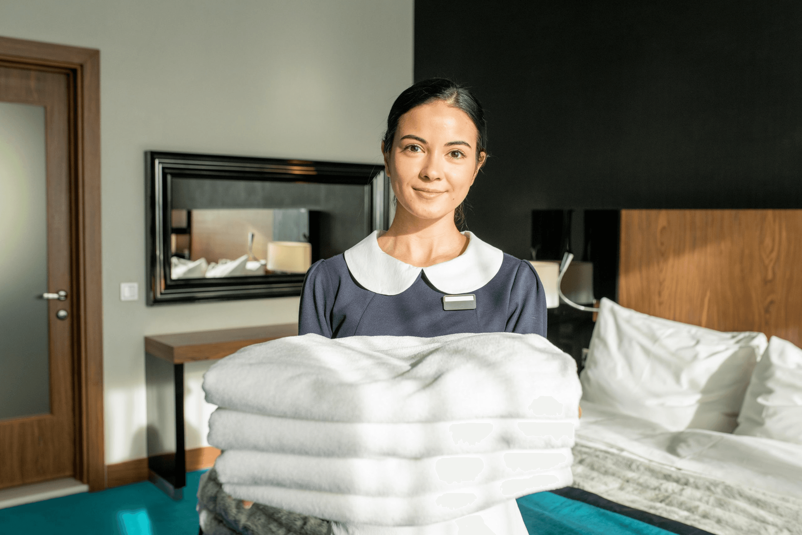 Housekeeper preparing a guest room