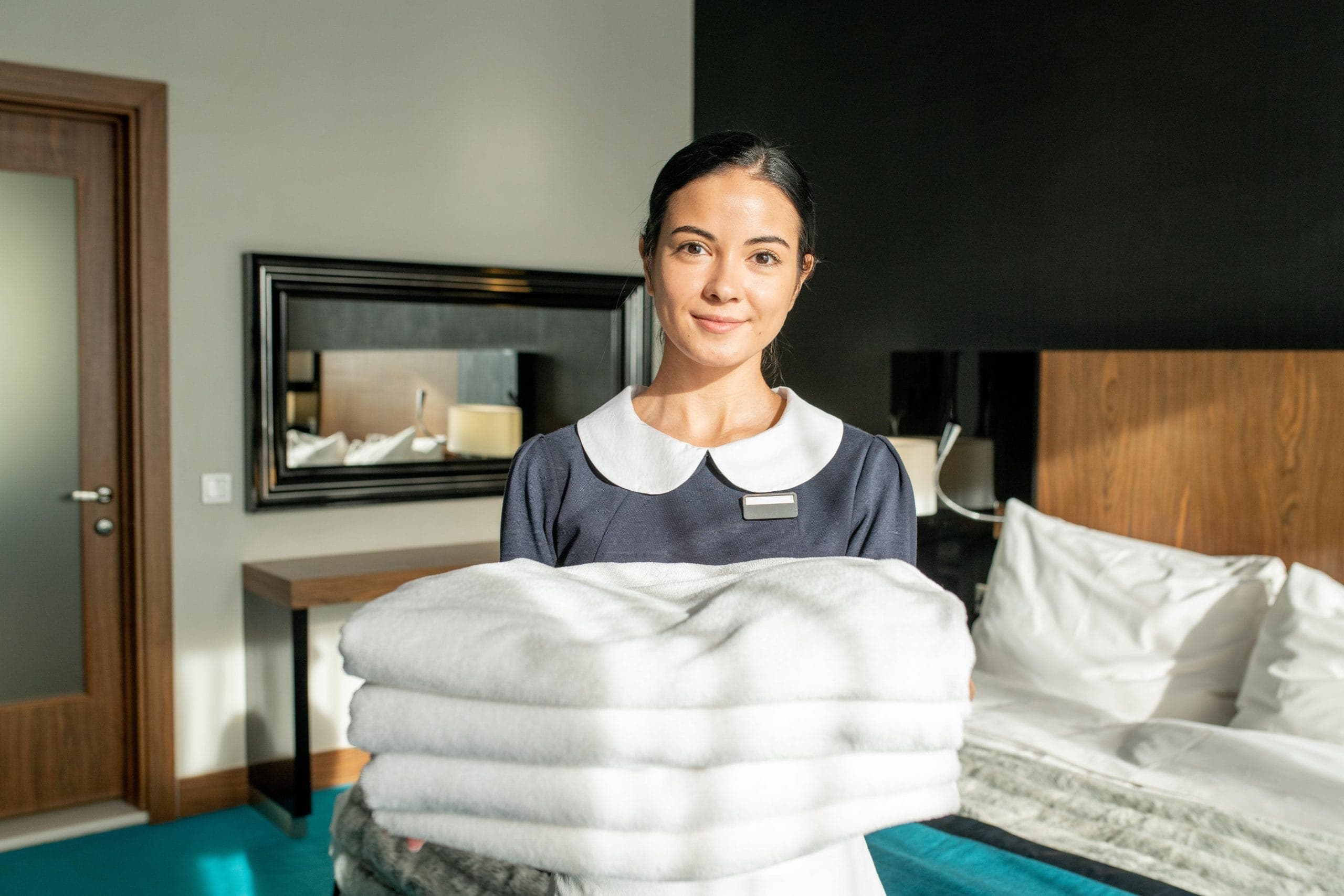 Housekeeper preparing a guest room