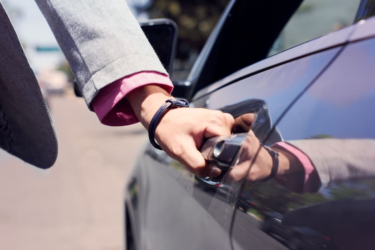 Valet attendant opening a guest's car door