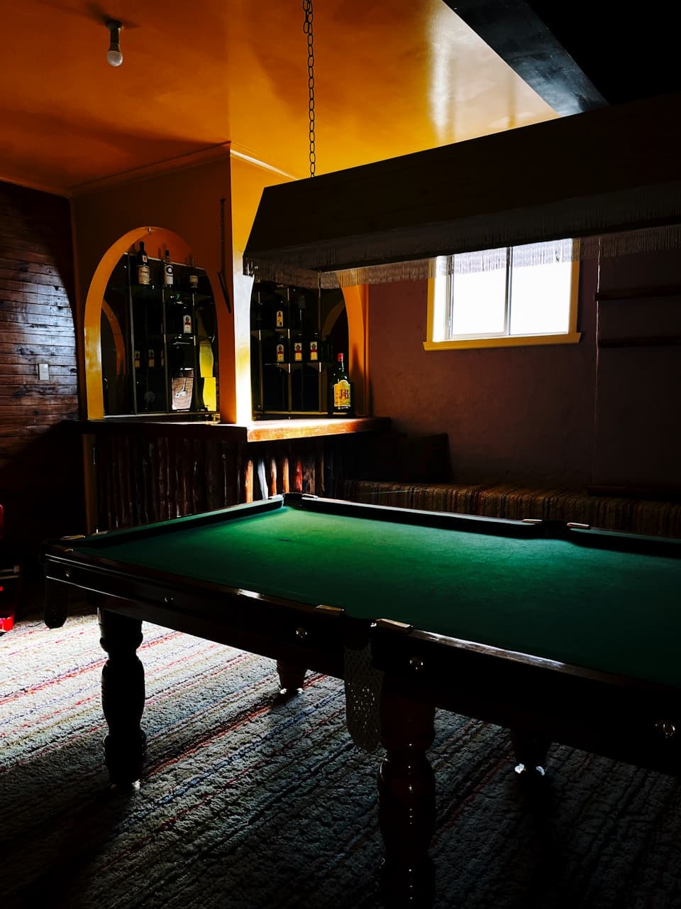 Gaming room with billiards table and lounge seating